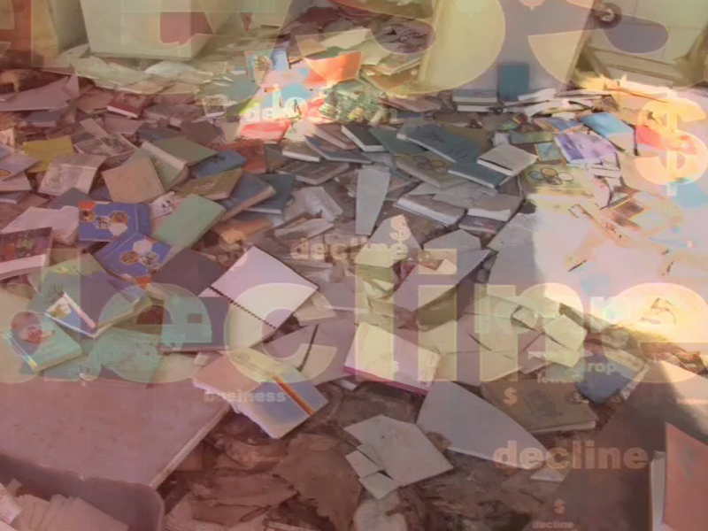 books scattered in a derelict room