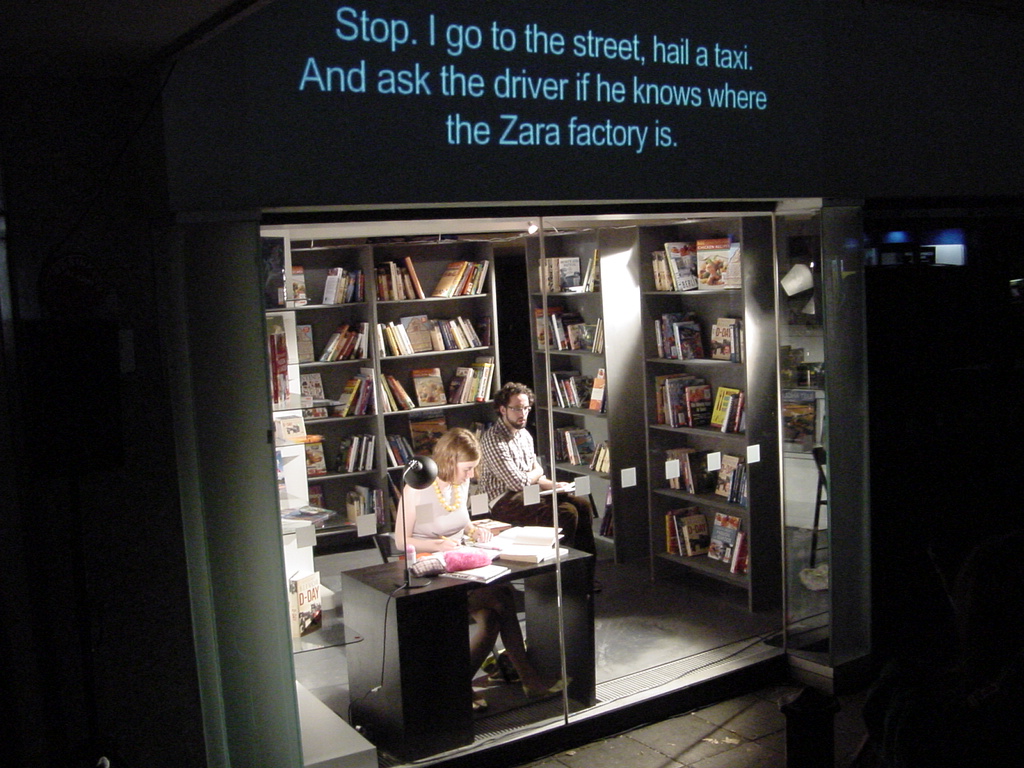 Pictures of Two actors in a shop window with subtitles